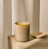 A Branch Basics 100% Beeswax Candle, housed in a glass jar with an organic cotton wick, displayed on a neutral background. - Thumbnail View 1
