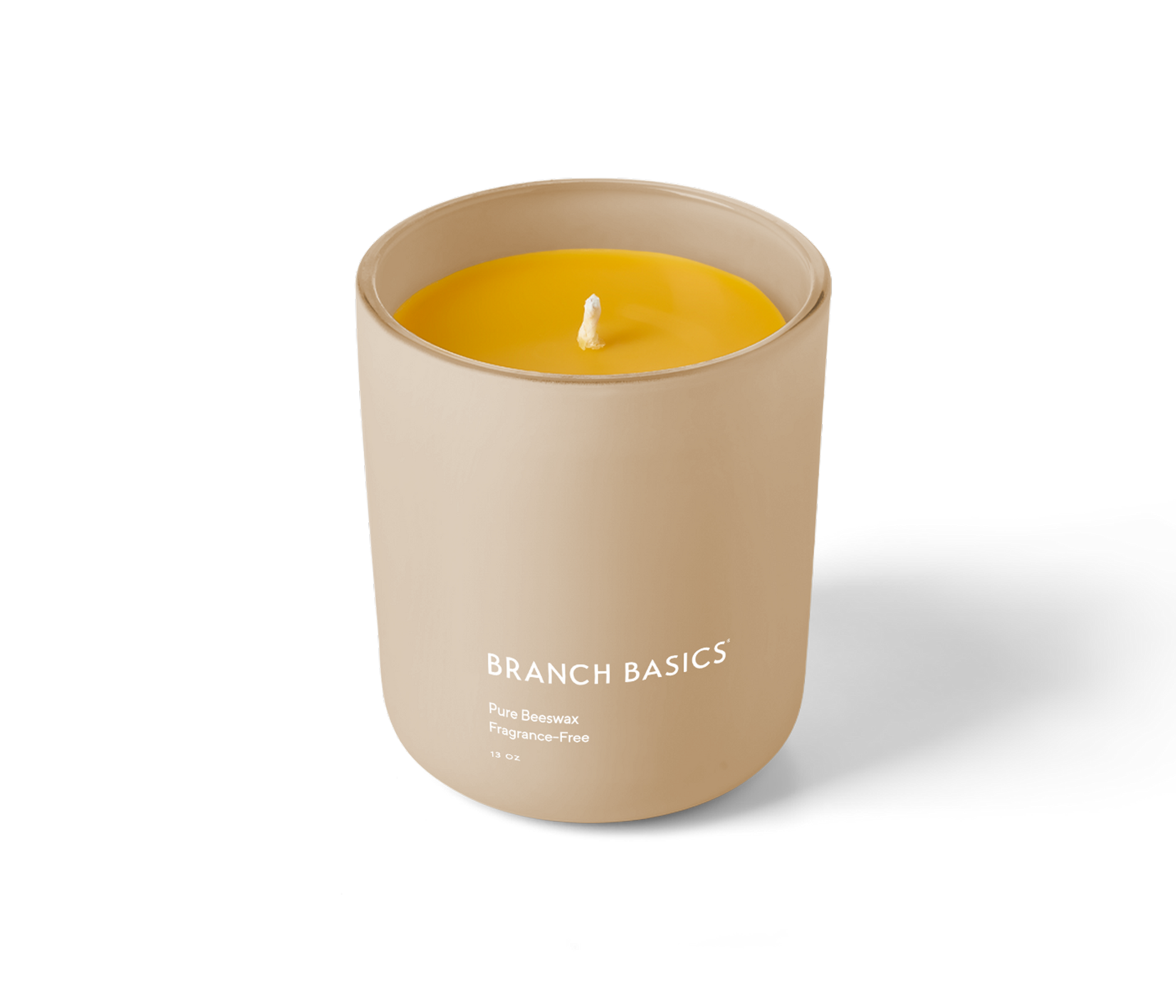 A Branch Basics 100% Beeswax Candle, housed in a glass jar with an organic cotton wick, displayed on a transparent background. - View 2
